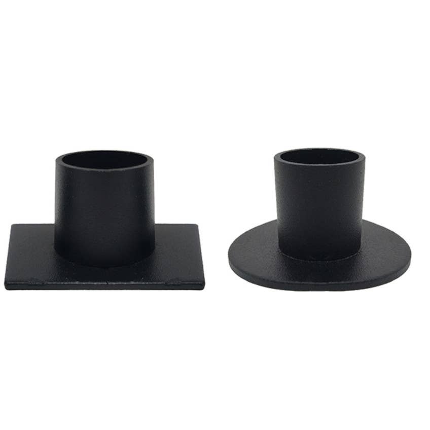 Two black metal taper candle holders on a white background