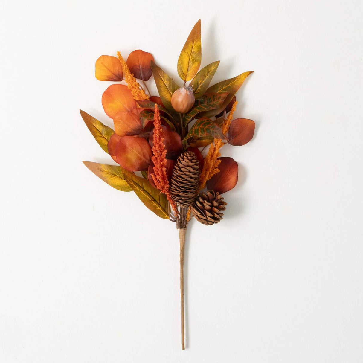 Artificial fall leaf arrangement with pinecones and acorns on a white background