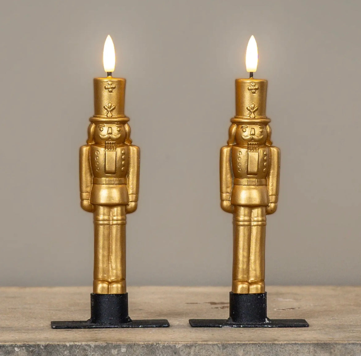 Gold nutcracker LED taper candles in 7.5" height, featuring a sculpted design and 3D moving flame.