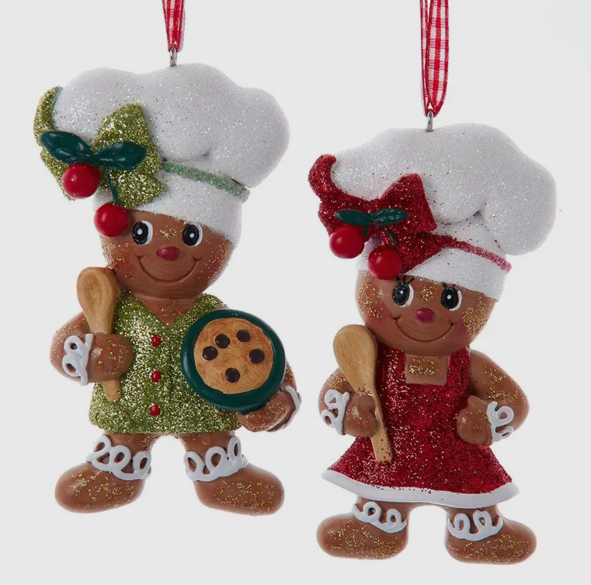 Two gingerbread chef-themed Christmas ornaments, one male and one female, on a white background.