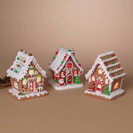 Candy Stripe Gingerbread Girl House: Lighted gingerbread house with candy‑stripe walls, gumdrop roof accents, and a gingerbread girl at the door.

Santa’s Candy Cottage: Lighted gingerbread house with Santa at the door, round candy windows, and peppermint roof accents.

Holiday Tree Gingerbread Man House: Lighted gingerbread house with green Christmas trees, red‑and‑white candy accents, and a gingerbread man at the door.