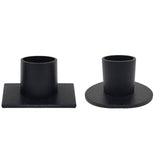 Two black metal taper candle holders on a white background