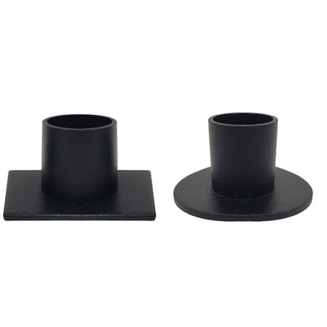 Two black metal taper candle holders on a white background