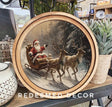 Decorative canvas art with Santa Claus in a sleigh and reindeer in a snowy scene.