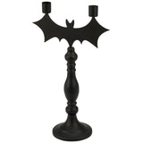 Matte black metal bat‑themed taper candle holder with two candle cups on the wings and a tall decorative base.
