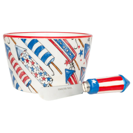 Patriotic Rockets 14 oz ceramic bowl with red rim and matching red, white, and blue rocket‑handled spreader by Rosanne Beck