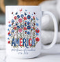 15oz ceramic mug with red, white, and blue florals, butterflies, and “America – 250 Years of Freedom 1776–2026” design.