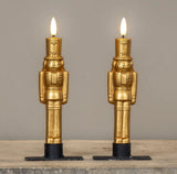 Gold nutcracker LED taper candles in 7.5" height, featuring a sculpted design and 3D moving flame.