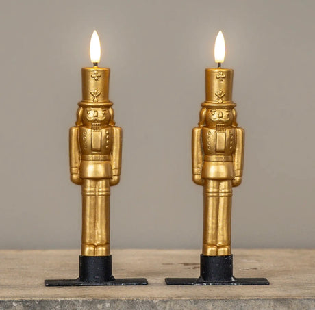 Gold nutcracker LED taper candles in 7.5" height, featuring a sculpted design and 3D moving flame.