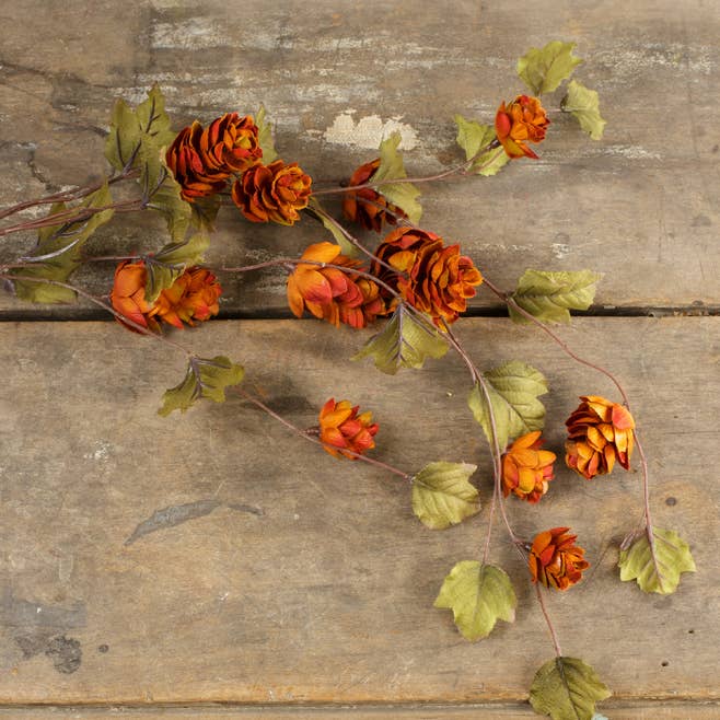 Sienna 39-inch faux hops stem with warm orange‑rust tones on a rustic wooden surface.