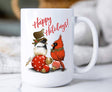 15oz ceramic Christmas mug with chickadee and cardinal perched on ornaments and “Happy Holidays” text.