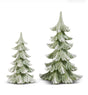 A set of two evergreen trees features softly carved branches in a light green finish accented with snow-tipped details. The layered branch design creates texture and dimension, while the snowy highlights give the trees the appearance of a gentle winter snowfall. The tallest tree measures 9 inches high.