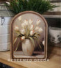 Arched canvas print of cream tulips with coral tips in a neutral vase, framed in wood by Redeemed Decor.