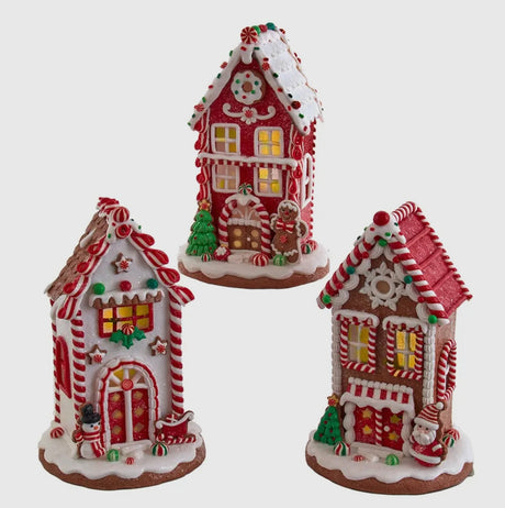 Three decorative gingerbread houses with candy details on a white background