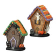 Two Halloween-themed miniature resin gingerbread cottages with ghosts, pumpkins, and candy corn details. 
