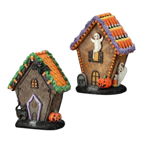 Two Halloween-themed miniature resin gingerbread cottages with ghosts, pumpkins, and candy corn details. 