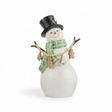 A whimsical snowman figurine wears a black glitter top hat and green plaid scarf while holding a draped garland of gingerbread cookie ornaments between twig arms. The dimensional garland features wood beads, gingerbread people, and Christmas tree cookies suspended across the snowman's body. A soft frosted finish, rosy cheeks, and bakery-inspired details create a charming Christmas display piece.