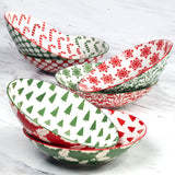 Winter Medley 9.25" porcelain dinner bowl with assorted red and green Christmas patterns, decorated inside and out, by Certified International