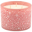 A three-wick candle in a pink glass container decorated with red and white candy canes, snowflakes, and white stars, shown against a plain white background.