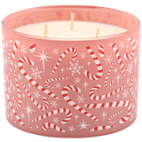 A three-wick candle in a pink glass container decorated with red and white candy canes, snowflakes, and white stars, shown against a plain white background.