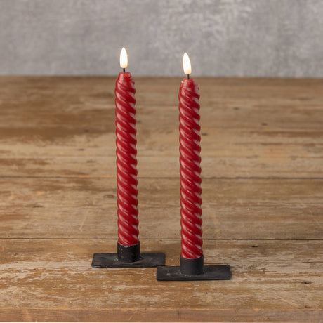 Red spiral LED taper candles with realistic 3D flame styled in black holders.
