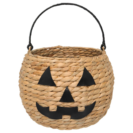 Round woven jack‑o‑lantern basket made of water hyacinth with black faux‑leather handle and cutout pumpkin face.